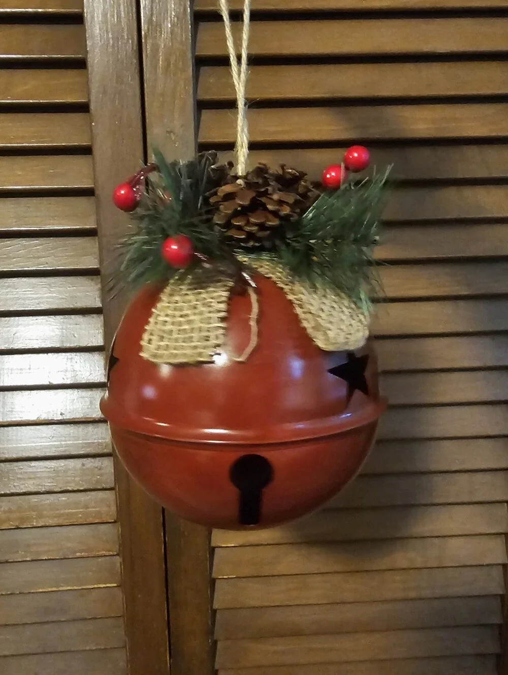Large Rustic Red Bell Christmas Decor with Star Cutouts & Burlap Bow